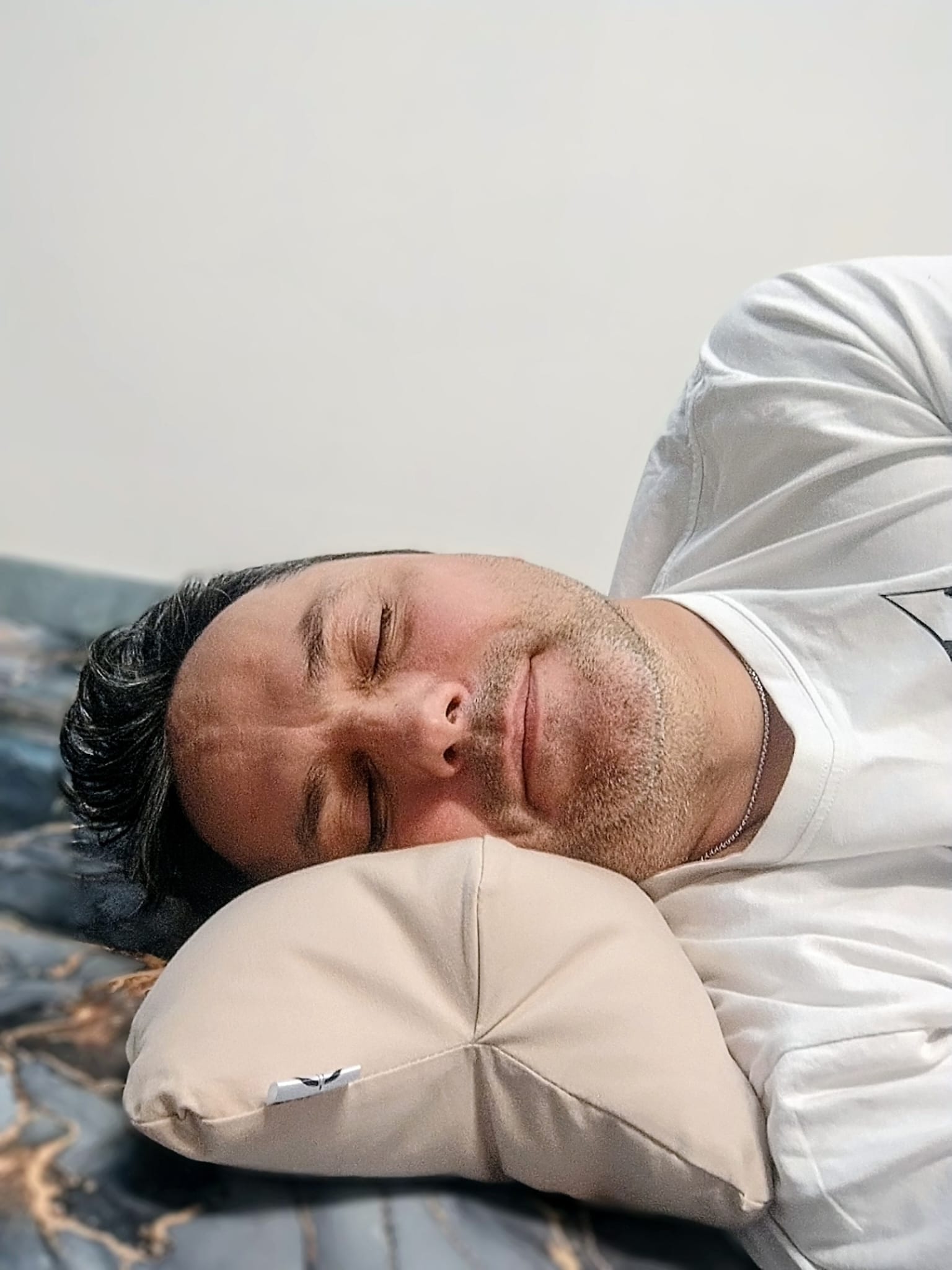 Mężczyzna śpiący na boku – poduszka Sunew, przyczyny chrapania i problemy z oddychaniem